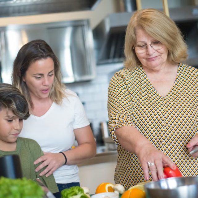 A family enjoys a cooking session together in a contemporary kitchen in Portugal.